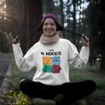 White sweatshirt featuring a colorful four-mood cartoon design with the text 'I HAVE 4 MOODS' above it.