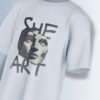 She Art Tee, close-up of 'SHE ART' hand-lettered text.