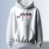 White hoodie with the word "NEVER" in a bold, slightly stylized, black font with red line accents.