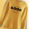 Bright yellow oversized sweatshirt with the phrase 'Life Is So Good' and a minimalistic smiley face.