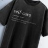 Distressed black oversized T-shirt with 'self-care' text, phonetic pronunciation, and definition.