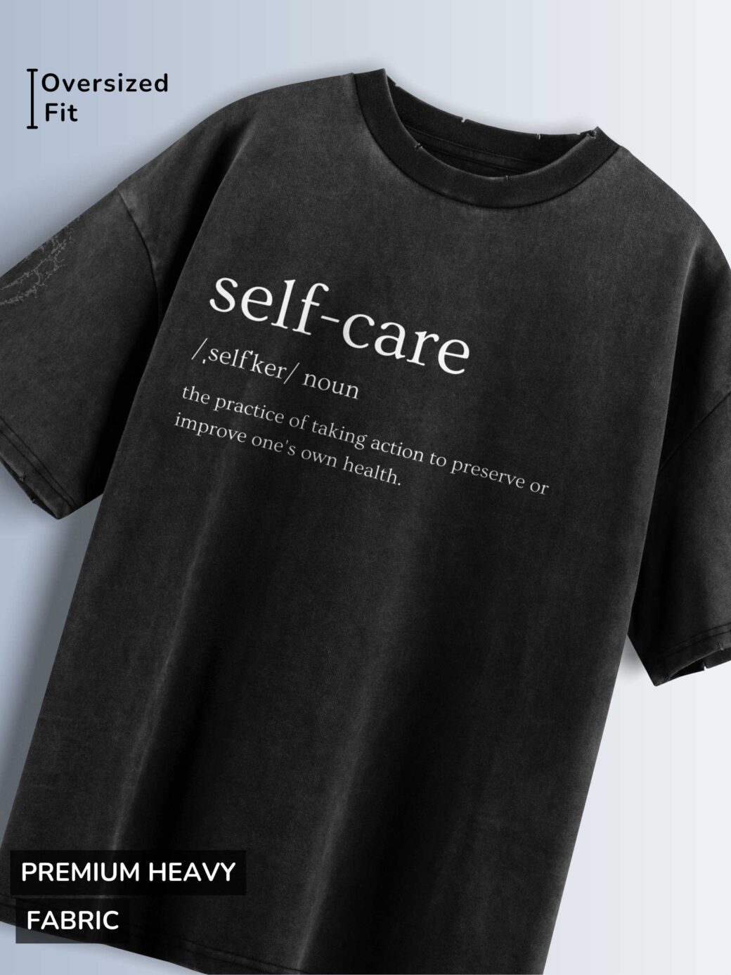 Distressed black oversized T-shirt with 'self-care' text, phonetic pronunciation, and definition.