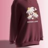 Maroon fleece sweatshirt with a daisy floral design and the phrase 'BLOOM & SHINE' in soft pastel colors.