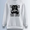 White fleece sweatshirt featuring a black cat holding a fish with the words 'FOOD LOVER' in bold typography.