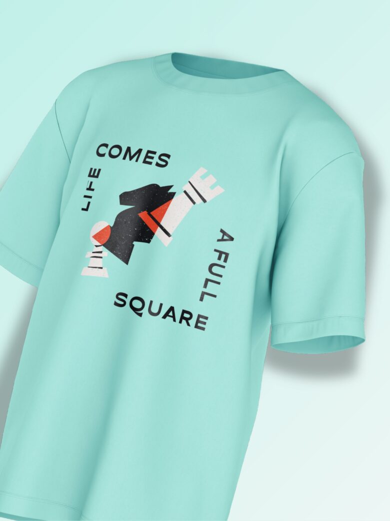 Mint green oversized T-shirt featuring an abstract black chess knight with typography reading 'LIFE COMES A FULL SQUARE'.