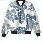 A white bomber jacket with a blue-gray Monstera leaf pattern, offering a nature-inspired and stylish look.