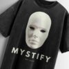 Distressed black oversized T-shirt with a blank mask graphic, 'MYSTIFY' text, and 'EST 2025' text.