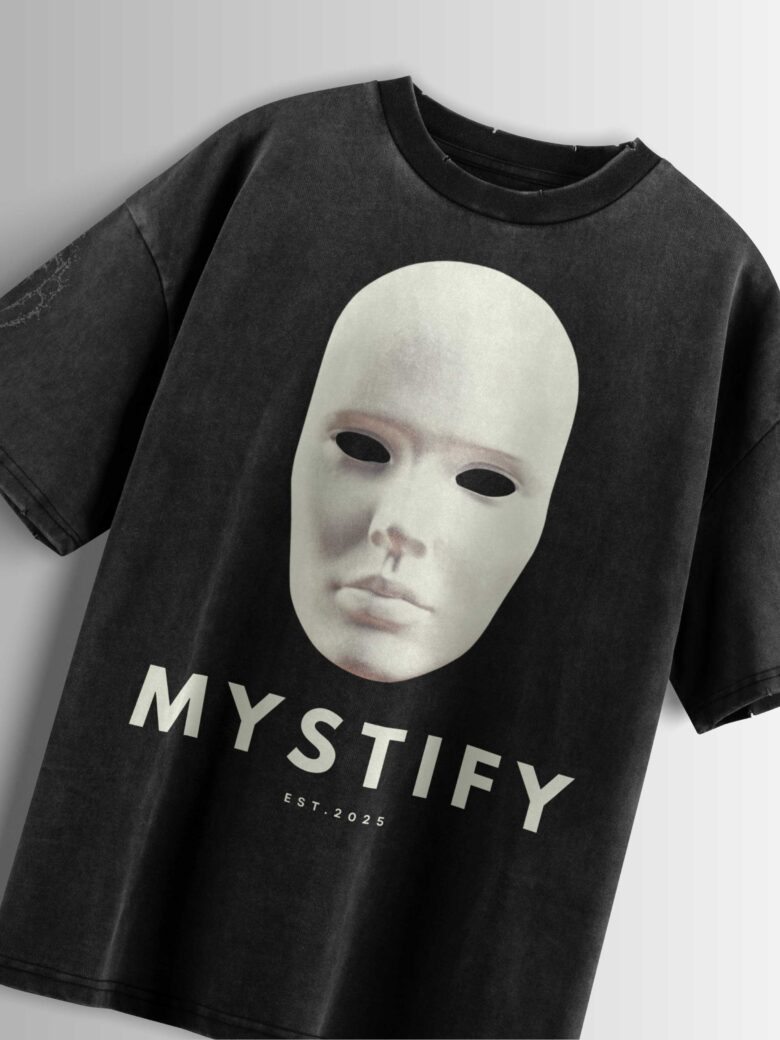 Distressed black oversized T-shirt with a blank mask graphic, 'MYSTIFY' text, and 'EST 2025' text.