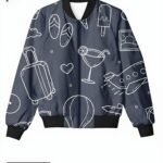 A dark gray bomber jacket with white line-art travel-themed doodles, including suitcases, airplanes, and cocktails.