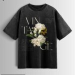 Distressed black oversized T-shirt with a vintage floral graphic and 'VINTAGE' text.