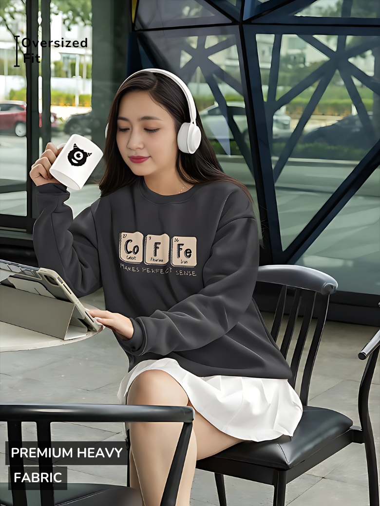 Black sweatshirt featuring a chemistry-inspired design spelling 'Co-Fe' with periodic table elements and the phrase 'Makes Perfect Sense' below.